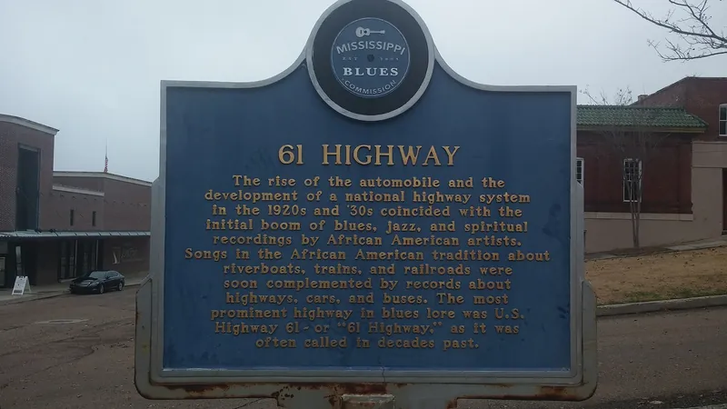 A Mississippi Blues Trail marker for Highway 61 beside the road in the Delta.