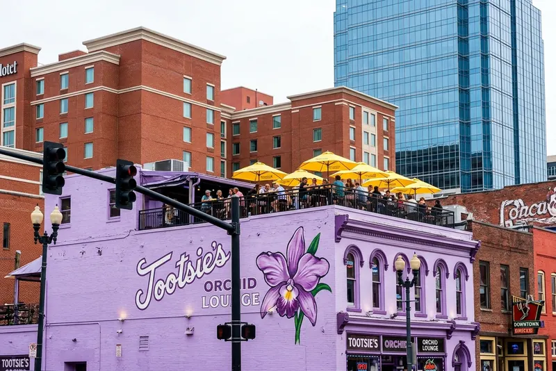 The lilac wall of Tootsie's Orchid Lounge on Lower Broadway in Nashville, a rooftop bar above.